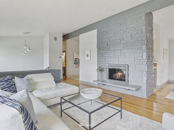 Circular floor plan great for everyday living or entertaining. Note the beautiful stone gas fireplace and complimentary stone 1/2 wall planter