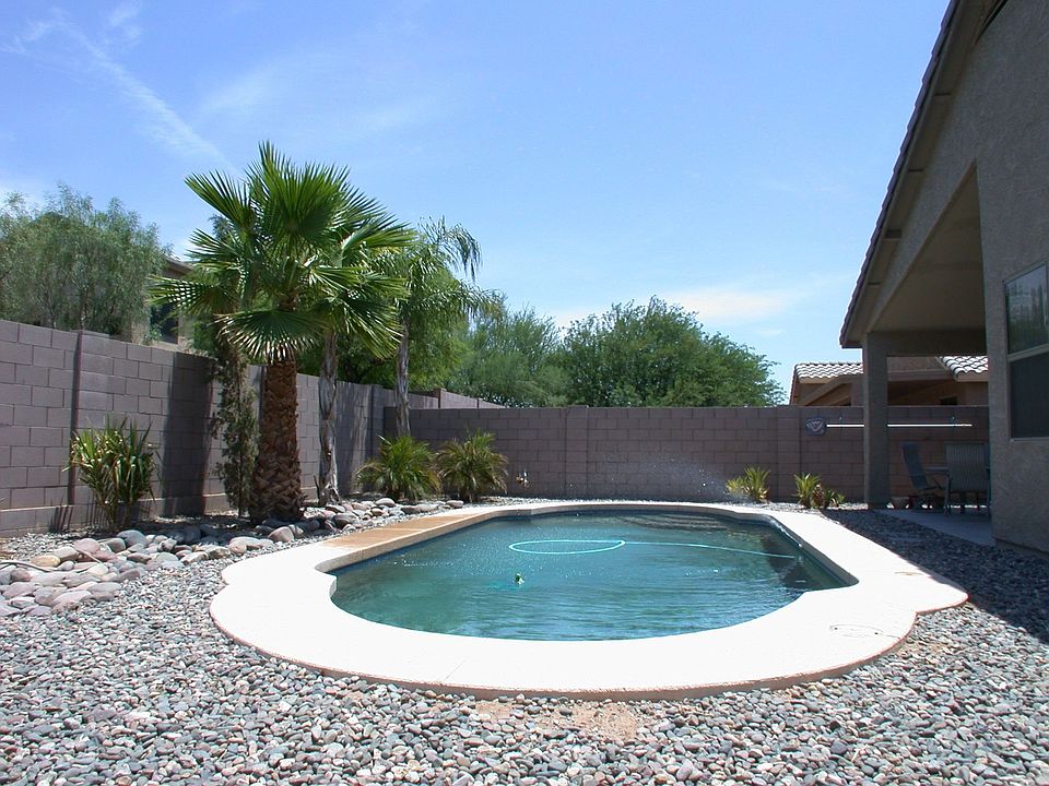 Create your own oasis in this private backyard around the inviting pebble-tec 