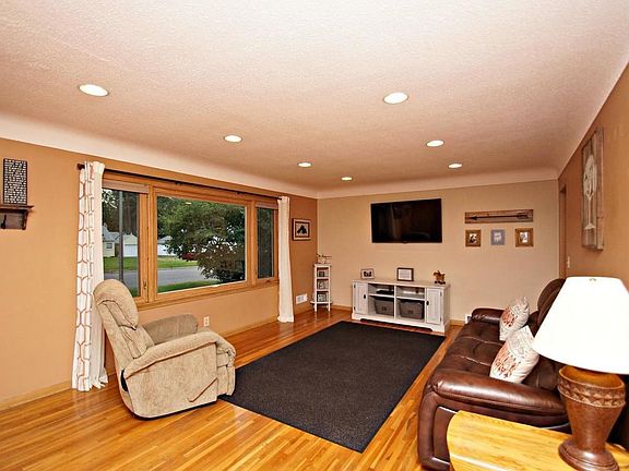 Large living room with gleaming hardwood floors, recessed lighting and check out the stunning cove ceiling.