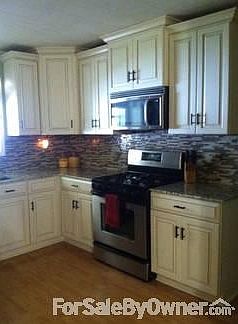 Granite countertops with glass and granite mosaic tiling.