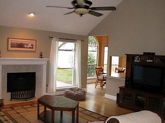 Another view of the living room shows the vaulted ceiling with beam.