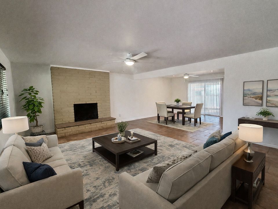 Living and dining room are virtually staged in this photo.