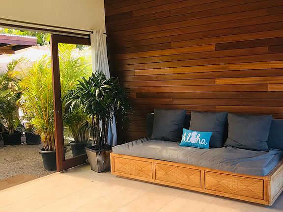 This is currently my office and entertainment room. Opens on both sides If needed can be converted to the second bedroom and to ocean views Wall has tropical hardwood from Bali.