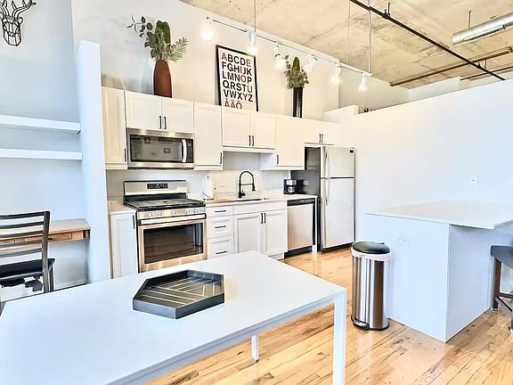 Kitchen and dining area, plus corner area for a 2nd work-from-home space, minibar, or coffee station