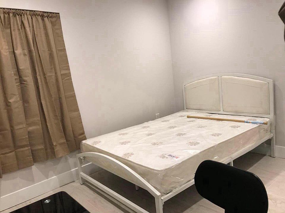 Basement front room with furniture and curtain