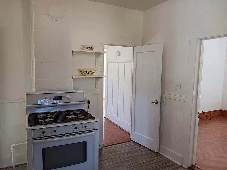 Kitchen with stove and shelves
