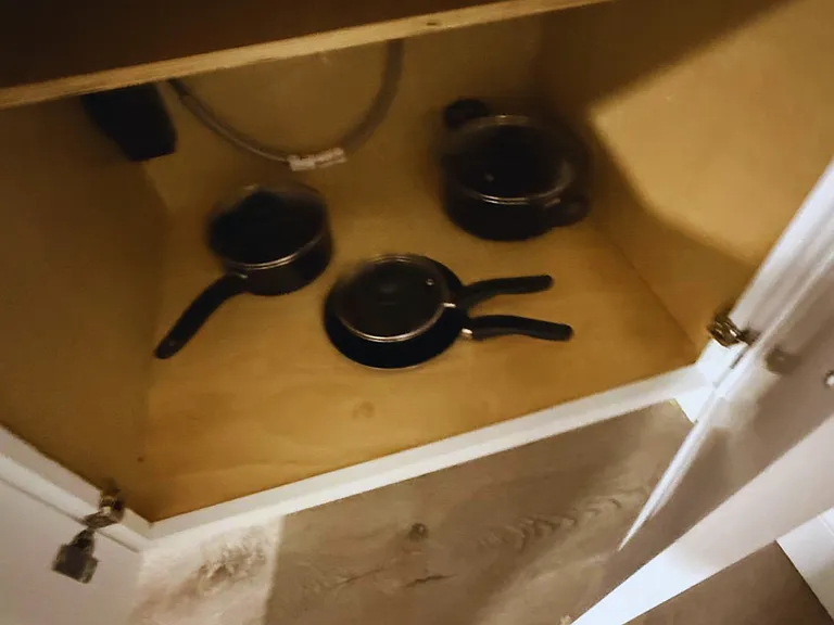 Fully stocked kitchen with pots, pans and essential cookware.