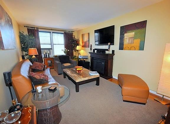 Large living room has gleaming hardwood floors and opens to the dining foyer.