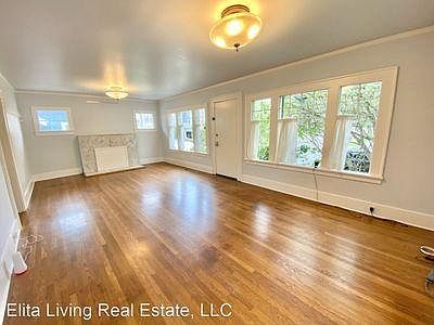 Light-filled upstairs living room with wood floors (throughout entire top floor).