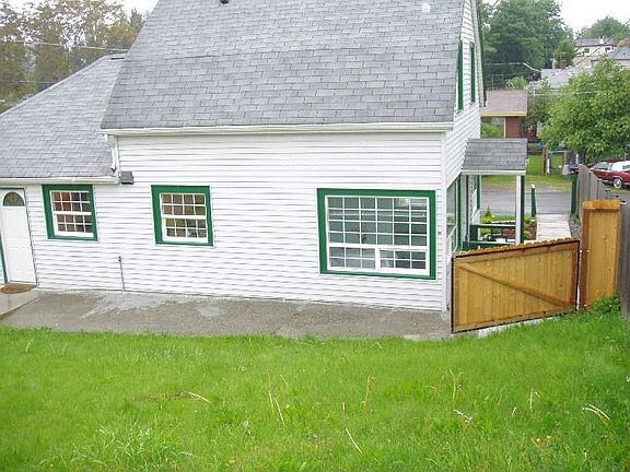 Back of the house/front door side from far corner of backyard