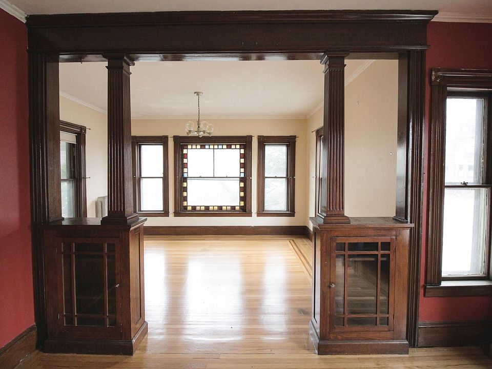 Double parlor with large stained glass window