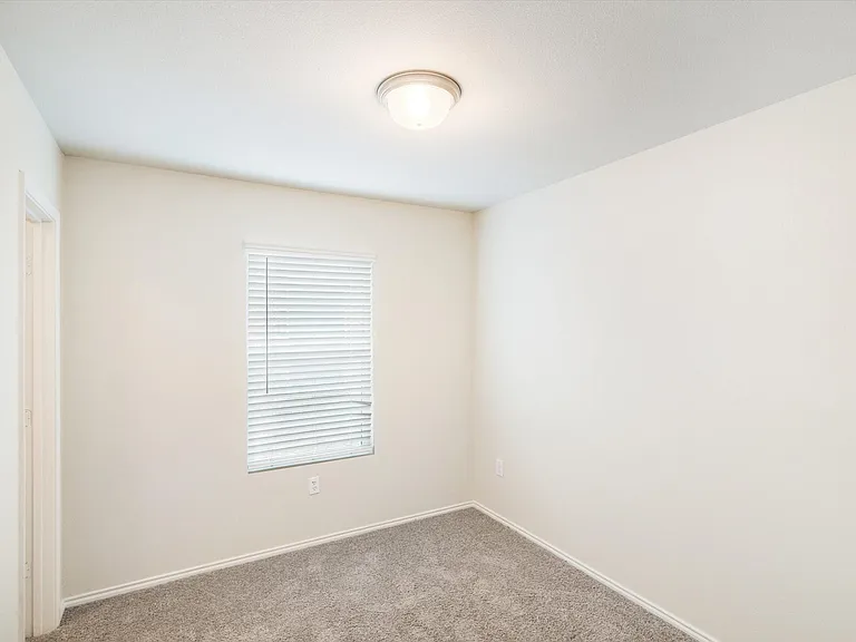 Neutral-toned walls complement the gray carpeting