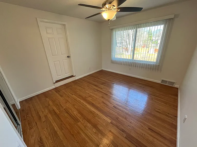Custom vertical blinds over a $4K Renewal by Anderson bay window - Clean and beautiful. NEW ceiling fan/light that matches 3 other rooms. Hardwood Oak is beautiful.