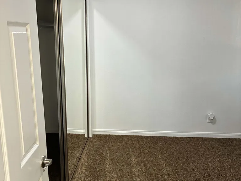 Cozy First Bedroom with Mirrored Closet Doors