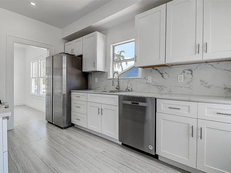 The stylish kitchen features stainless steel appliances and sleek quartz countertops, perfect for cooking and entertaining.