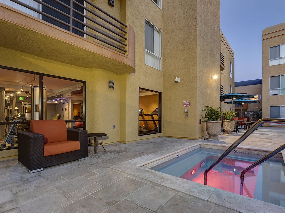 Apartments in Burbank, CA - Jacuzzi and Patio Area with Seating Lit Up at Night