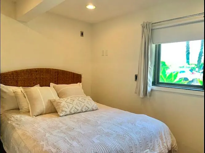 Bedroom with Queen Bed, Black Out Shades and TV.