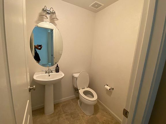 1/2 bathroom downstairs between the entrance and the kitchen/family room area.