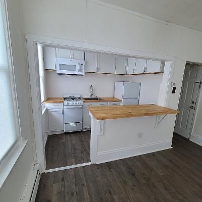 Kitchen with microwave, gas range and refrigerator