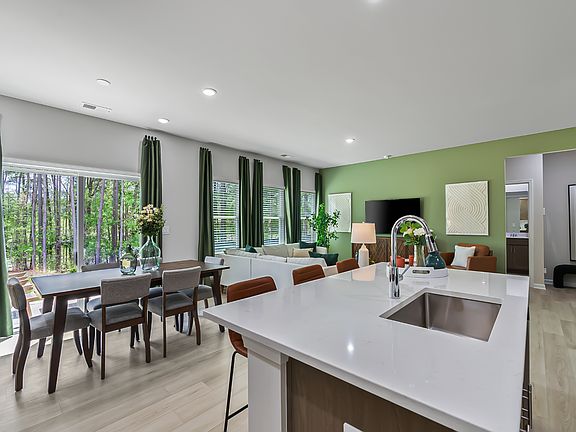 The kitchen provides ample prep and storage space with a sizeable island overlooking the great room.