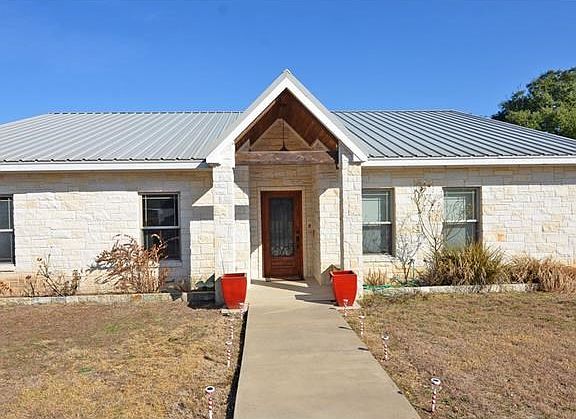 Greet your guests from this landscaped from porch.