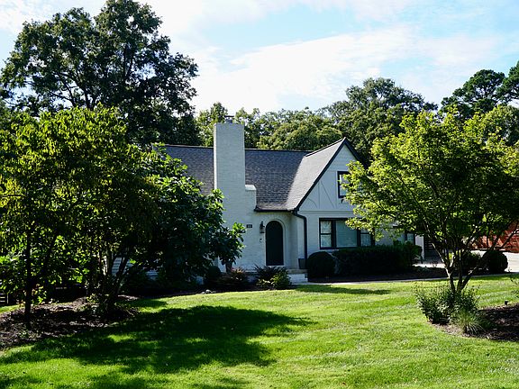 Large frontward with mature landscaping