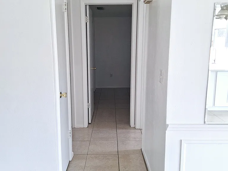 Hallway leading to bedrooms/bathroom and two hall closets.