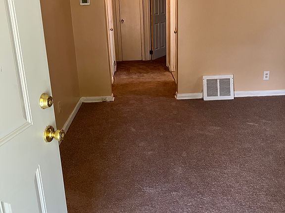 Entering front door into living room. New carpet throughout the house.