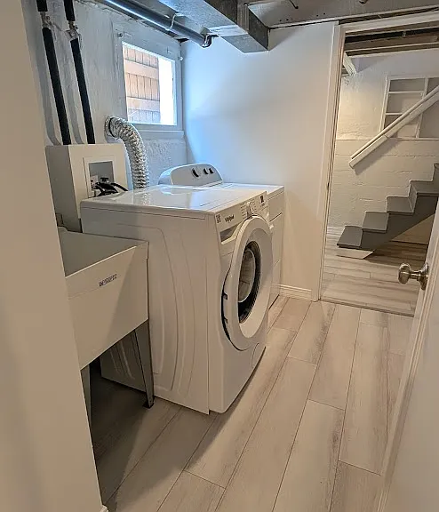 Laundry with new utility sink, faucet, and plumbing.