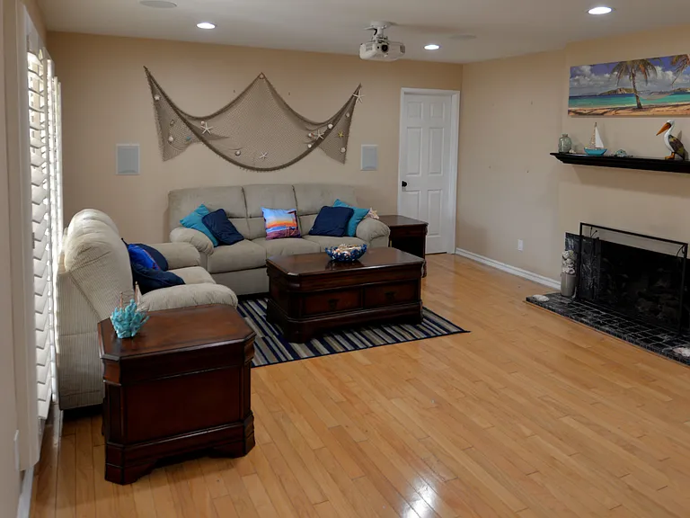 Ceiling mounted projector with in-wall surround system for home theater experience.