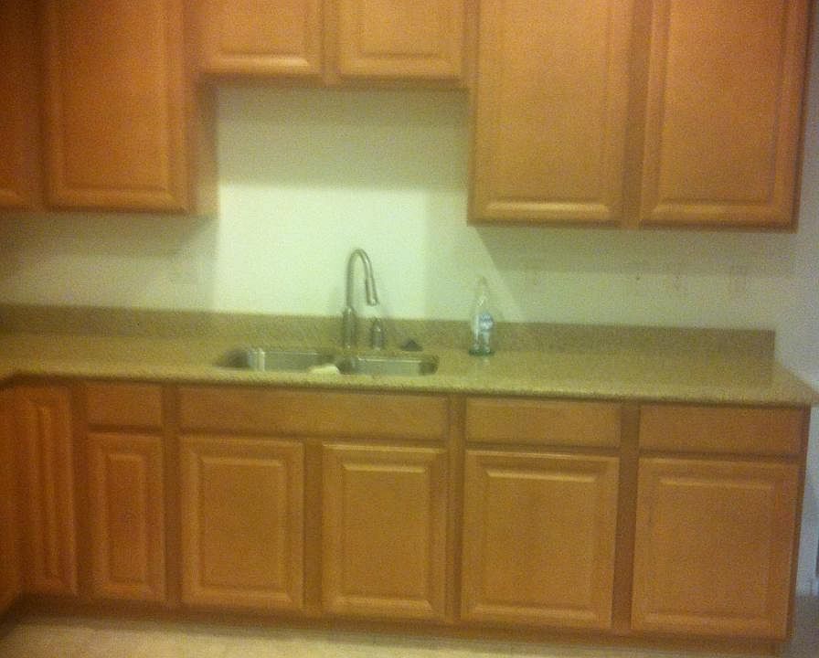 Granite kitchen counter and stainless steel sink.