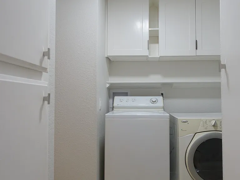 Laundry: Washer Dryer with overhead Storage Cabinets and shelving.
Separate Linen Cabinet