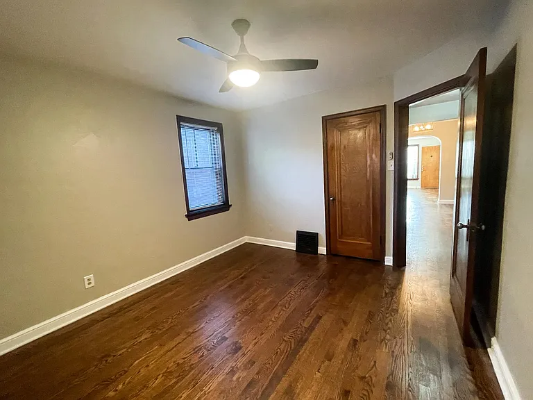 Another view of bedroom and entry door.