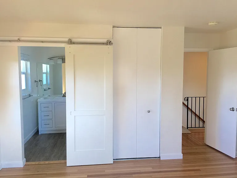 Primary Bedroom into Primary Bathroom with Barn Door