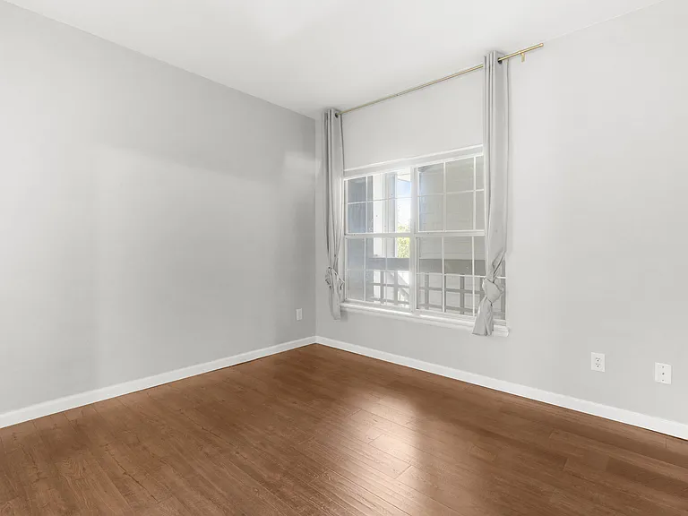 Versatile second bedroom ideal for use as a guest room, home office, or both.