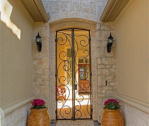 Walk through the spiral detailed iron gate into the courtyard.