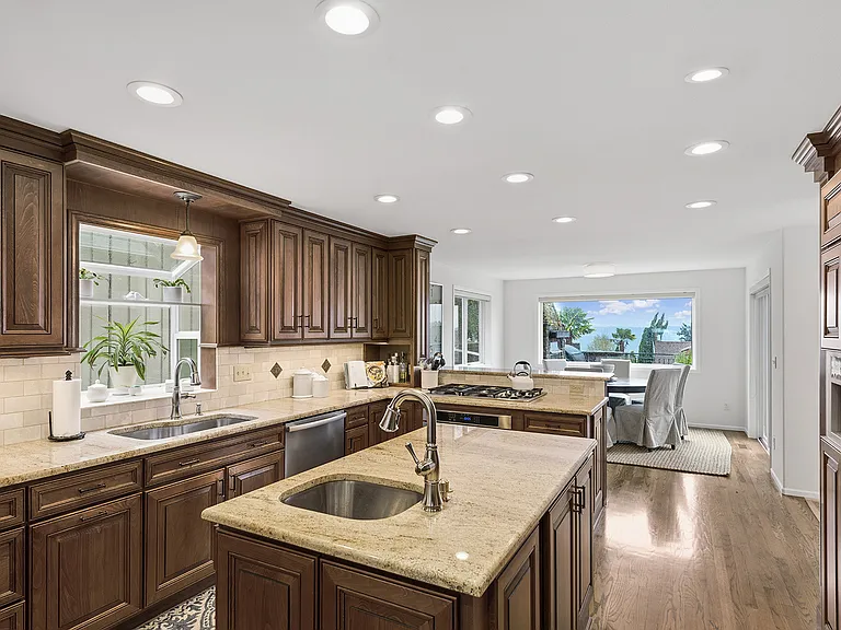 Epicurian Kitchen with same views! Island, prep sink, gas cooktop, Miele dishwasher. Photo looking from Kitchen toward Dining Room