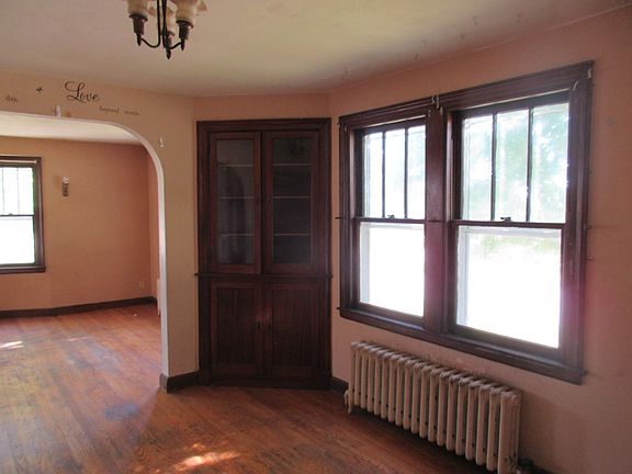 This is the formal dining room with lots of light and built-ins. This room has hardwood floors.