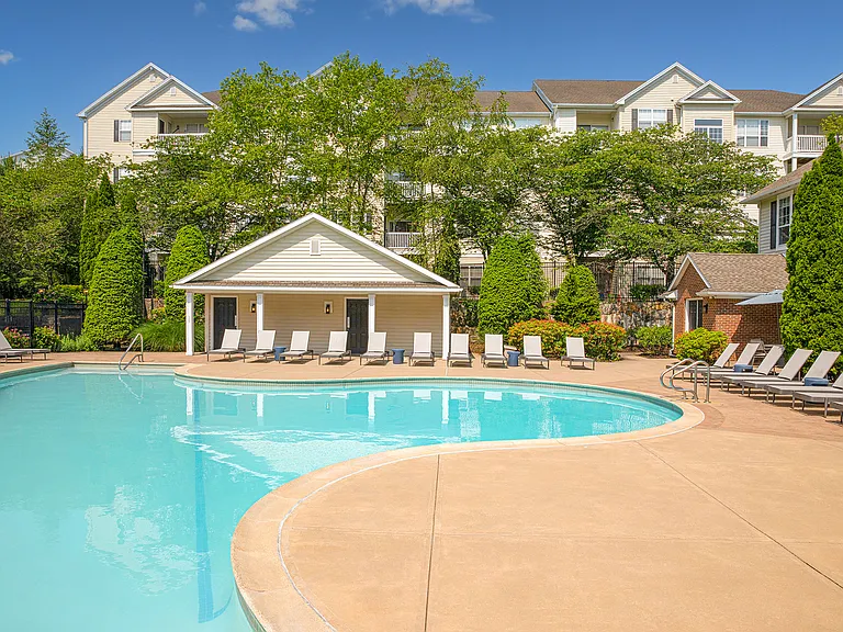 Expansive resort-style heated swimming pool with fountain and sundeck