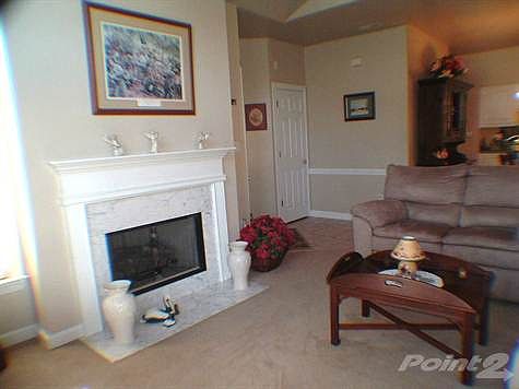 Living room has cosy gas log fireplace