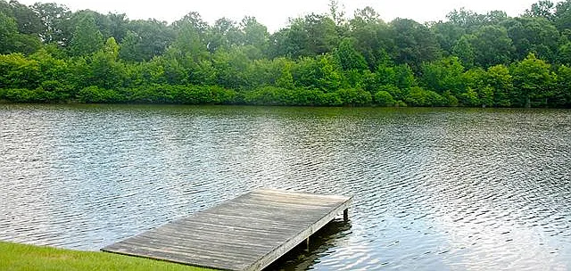 Village Lakes has 4 miniature lakes for kayaking, boating, and fishing. View of lake and dock behind home.