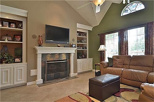Down stairs family room has slate surrounding the gas log fireplace, wonderful built ins, cathedral ceilings and surround sound.