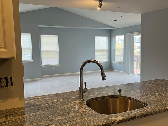 Kitchen peninsula opens to cathedral ceiling great room