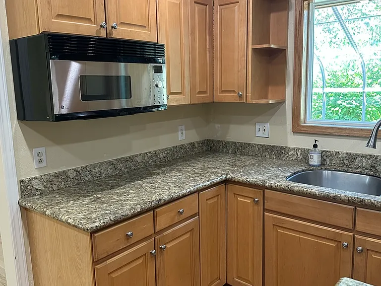 Kitchen sink and microwave, Stovetop is in bottom right
