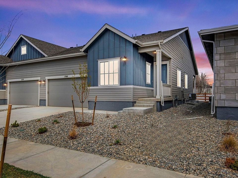 Sleek modern farmhouse exterior, featuring an attached 2-bay garage