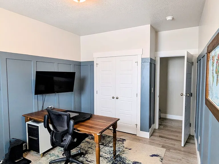 Bedroom set up as a home office. Office table to stay, other furnishings (file cabinets and chair) will not stay.