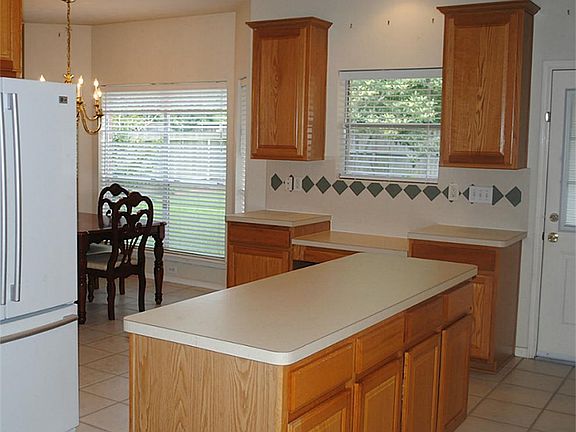Wonderful work triangle in the island kitchen. Look at the storage in the island & the built-n desk area!
