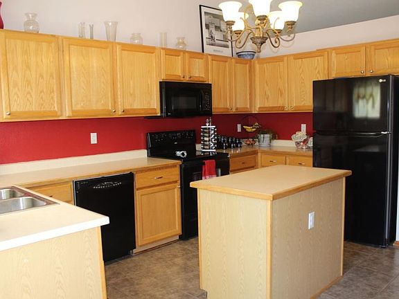 Black appliances with smooth surface range top.