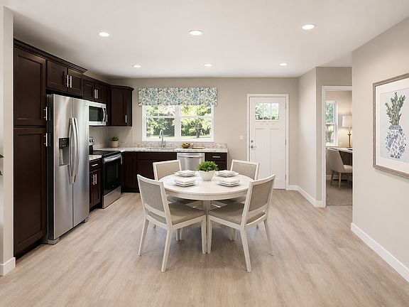 Inviting eat-in kitchen with updated appliances, generous counter space, and sunlit dining area.