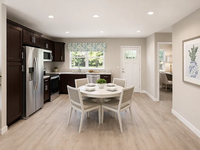 Inviting eat-in kitchen with updated appliances, generous counter space, and sunlit dining area.